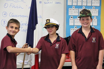 In this photo Jerry Ventouras, Class General and Tom Ockerby Class Captain are handing over the flag to the new general Jack Saggers.